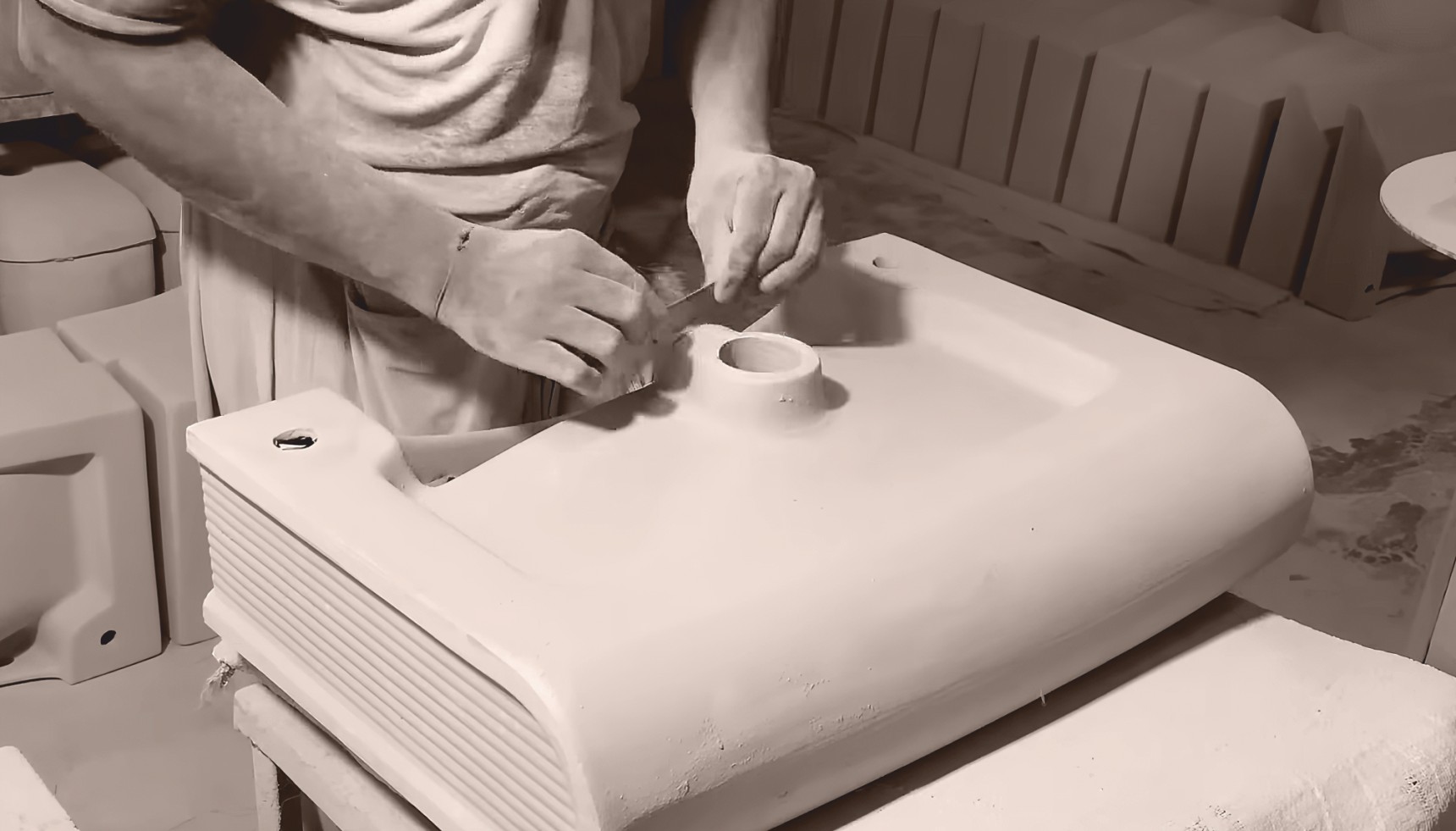 Craftsman shaping sanitaryware by hand